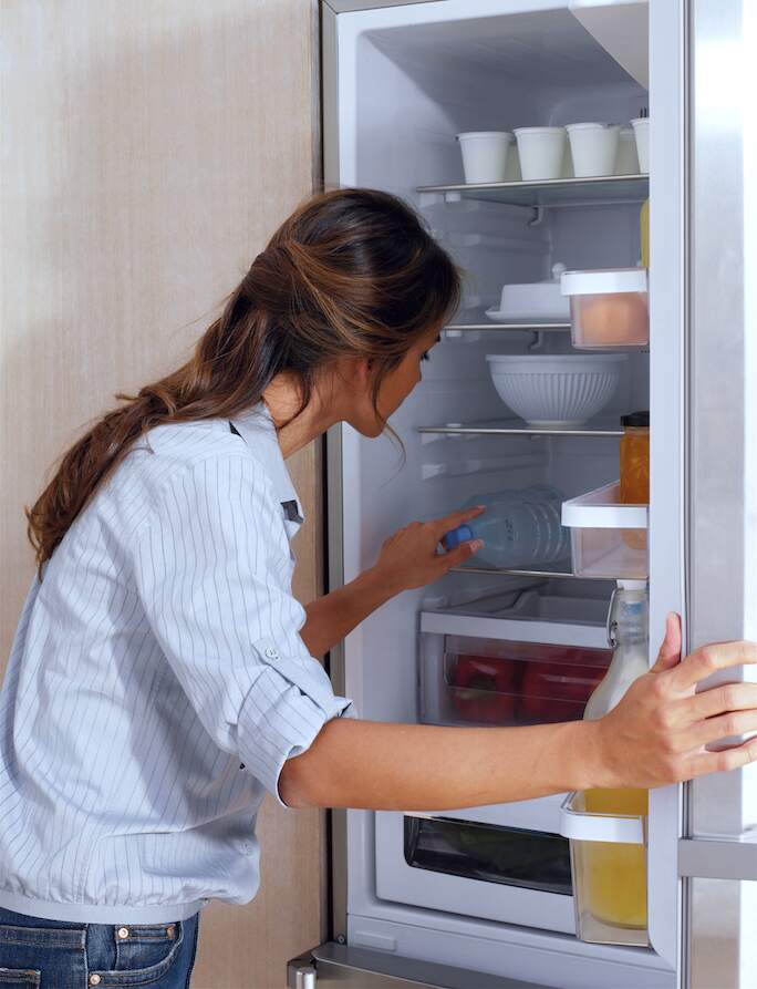 A woman opened a refrigerator