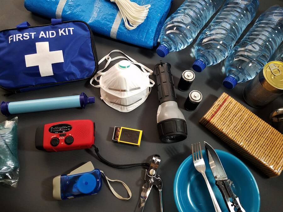 Emergency items such as a first aid kit, bottled water, masks, tools and flashlight